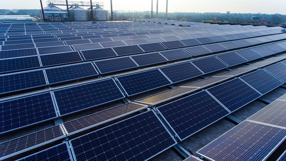 Solar panels mounted on building roof for producing clean ecological electricity